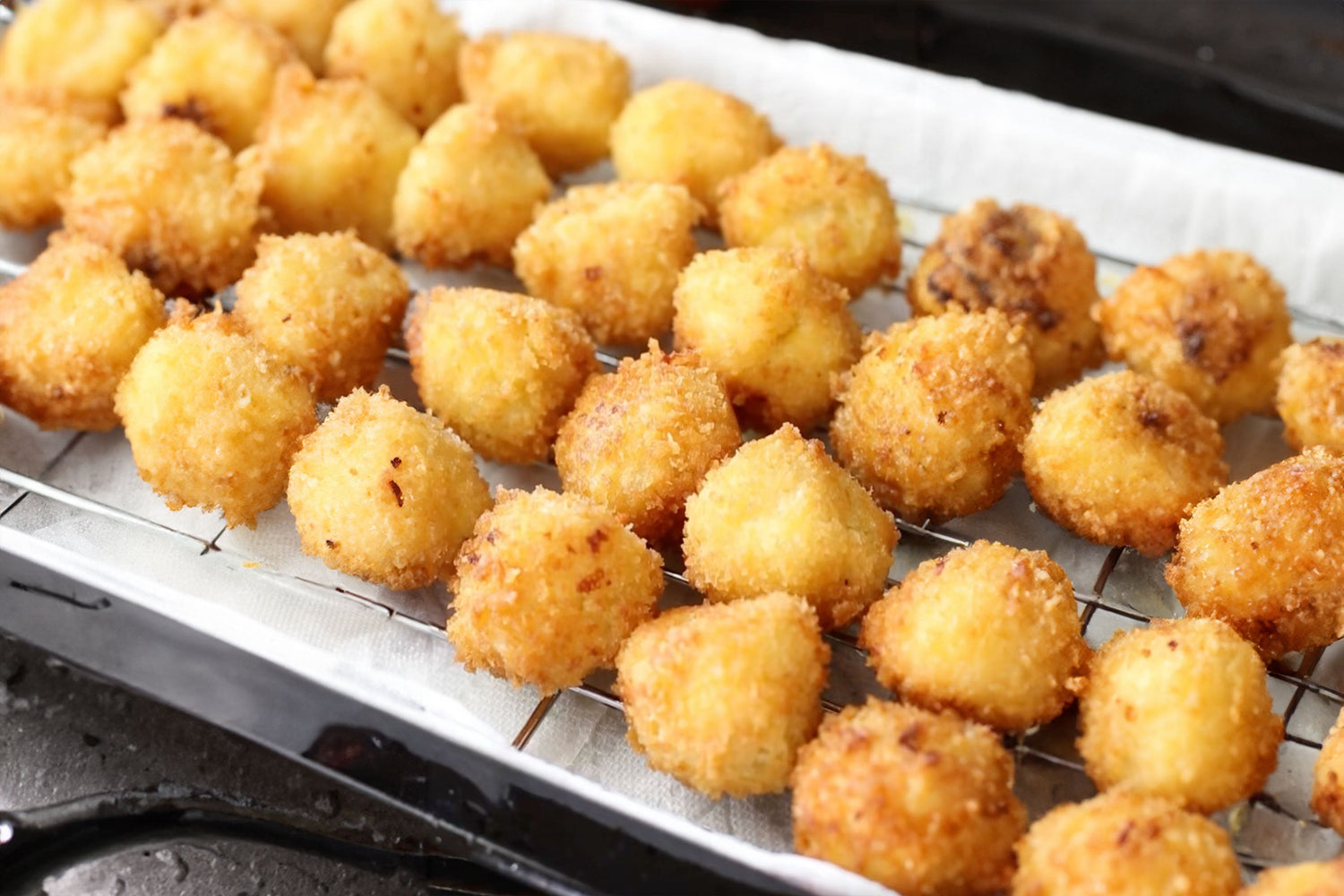Fried mac and cheese balls with tomato and basil sauce