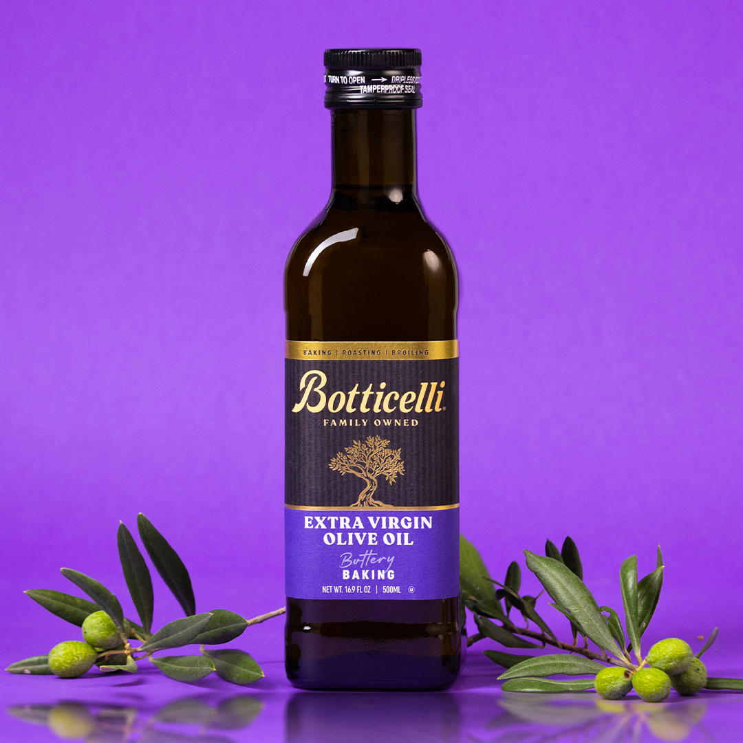 Bottle of Botticelli Baking extra virgin olive oil with olive branches on a purple background