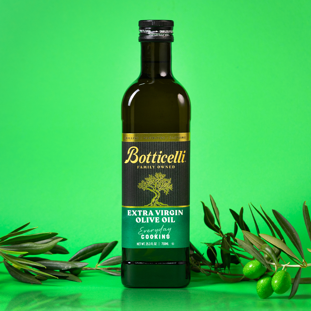 Bottle of Botticelli cooking extra virgin olive oil on a green background with olive branches.