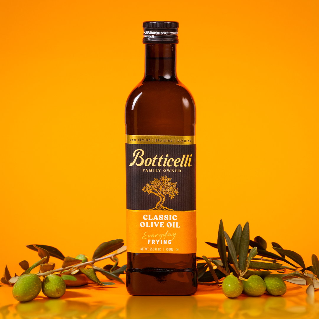 Botticelli frying olive oil bottle with olives on an orange background