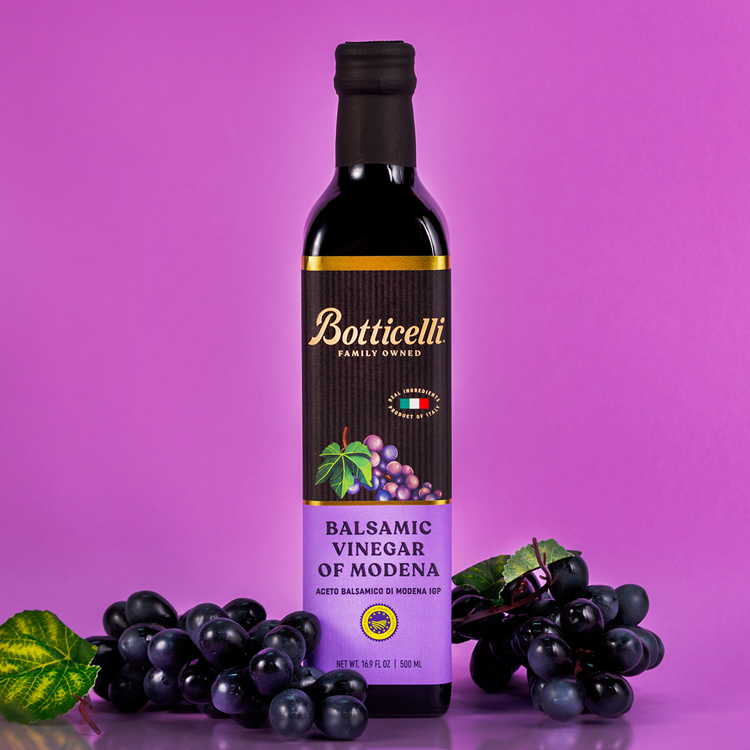 Botticelli balsamic vinegar bottle with grapes on a purple background