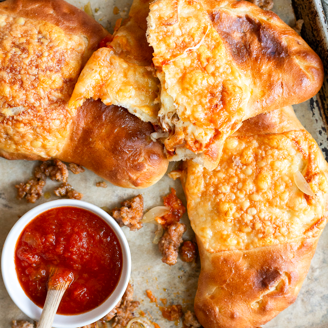 cheesy calzones with caramelized onion pasta sauce