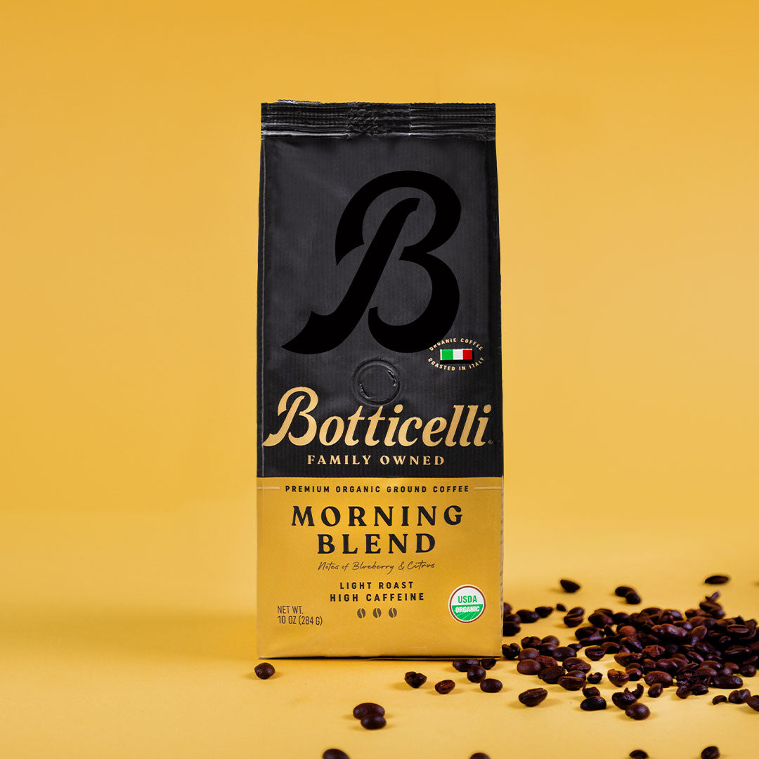 Botticelli Morning Blend coffee package on a yellow background with scattered coffee beans.