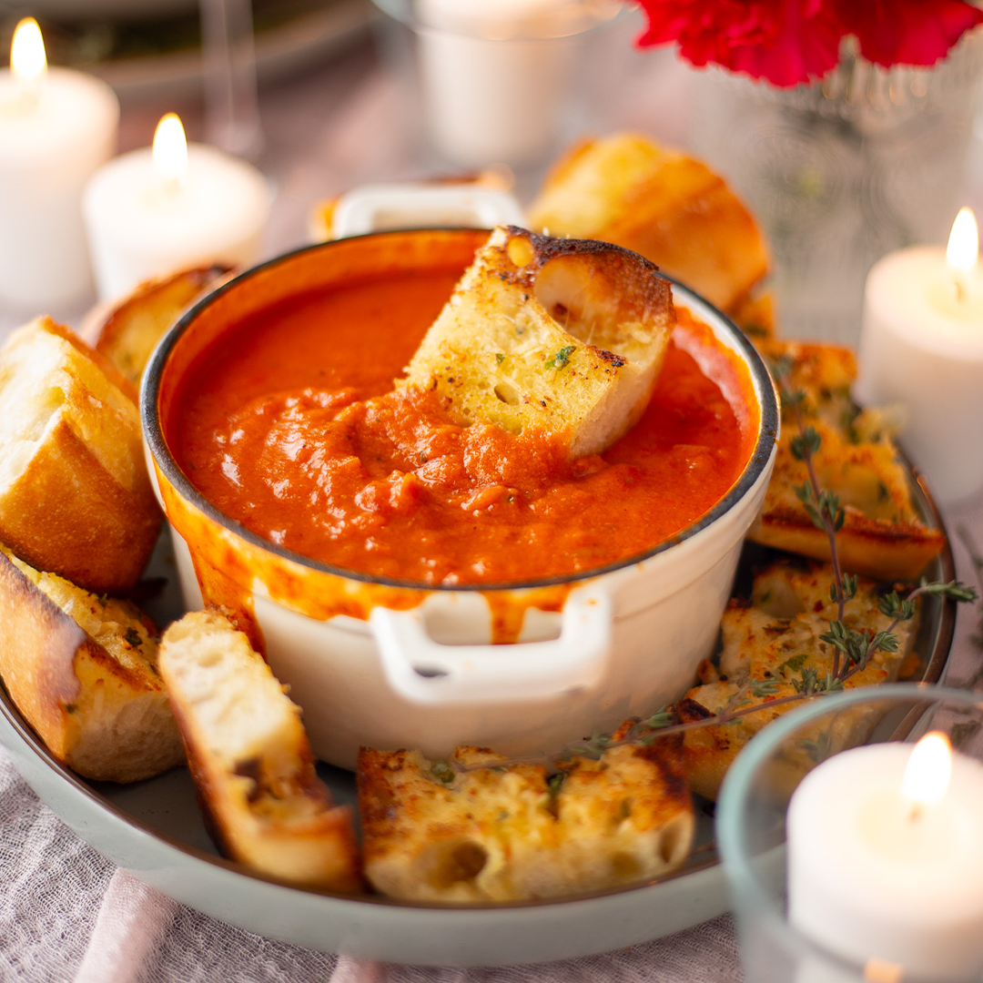 fresh garlic bread dipped in pasta sauce