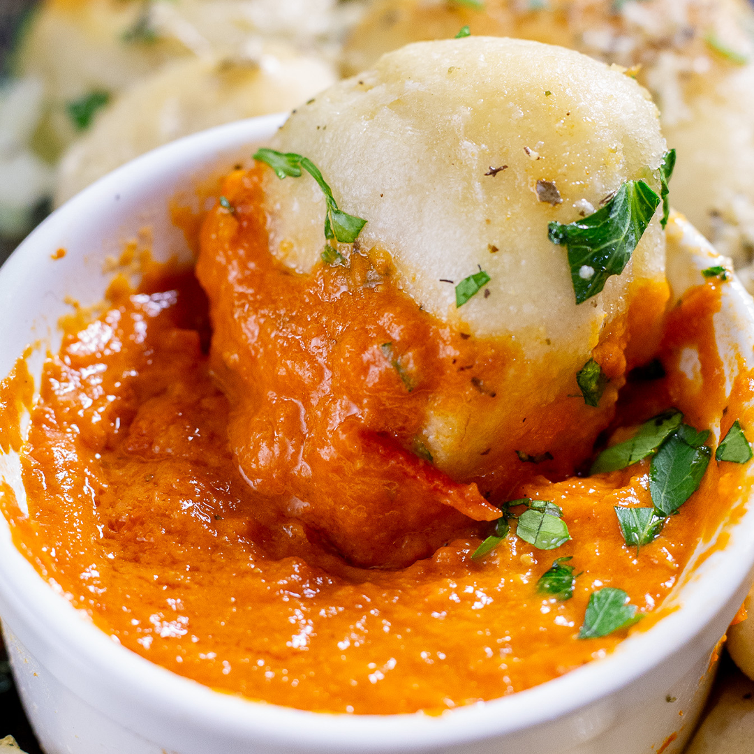 garlic knots dipped in spicy vodka pasta sauce