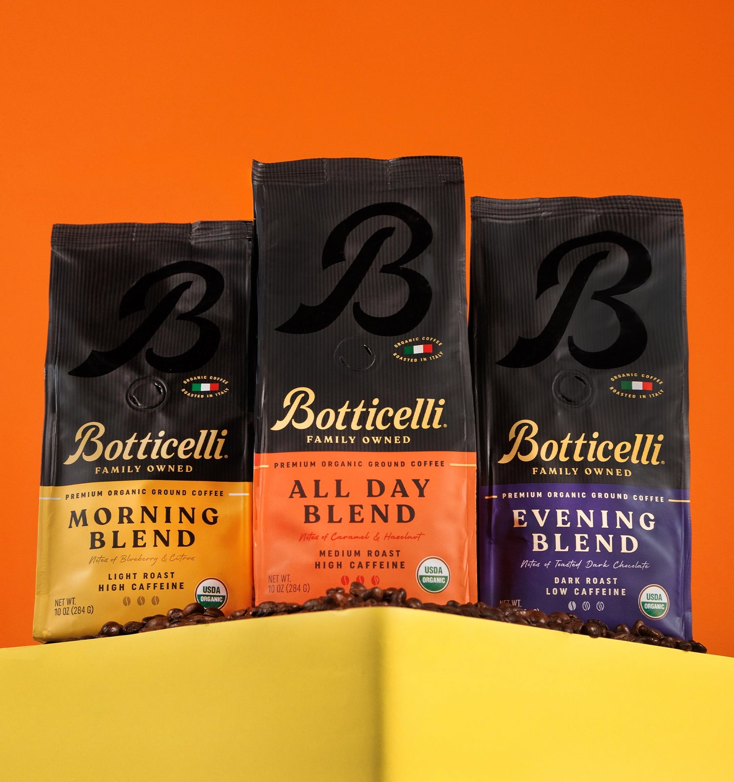 Three Botticelli coffee bags labeled 'Morning Blend', 'All Day Blend', and 'Evening Blend' on an orange background.
