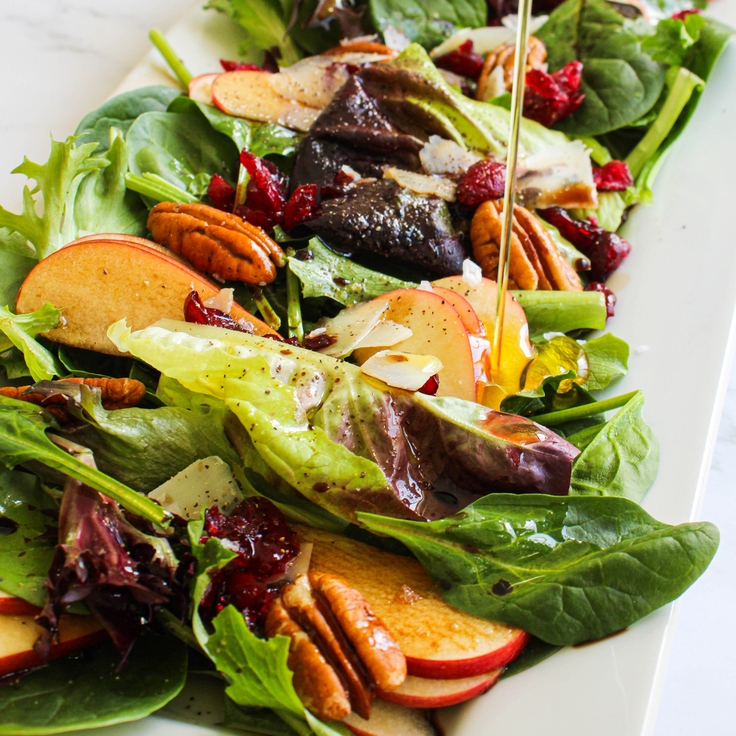 salad with oil pouring over