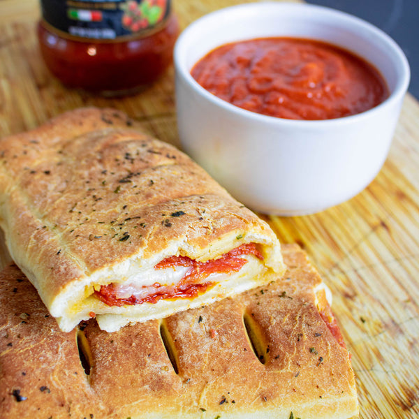Homemade hot pocket dipped in Traditional Pasta Sauce