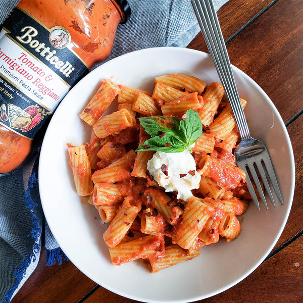 Plate of rigatoni topped with tomato and Parmigiano Reggiano pasta sauce