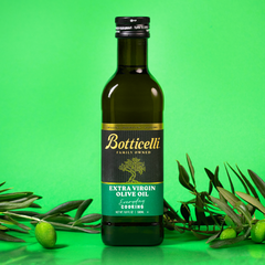 Bottle of Botticelli cooking extra virgin olive oil with green background