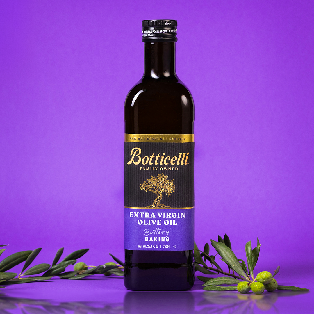 Bottle of Botticelli baking extra virgin olive oil on a purple background with olive branches.