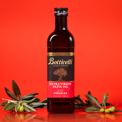 Bottle of Botticelli finishing extra virgin olive oil on a red background with olive branches.