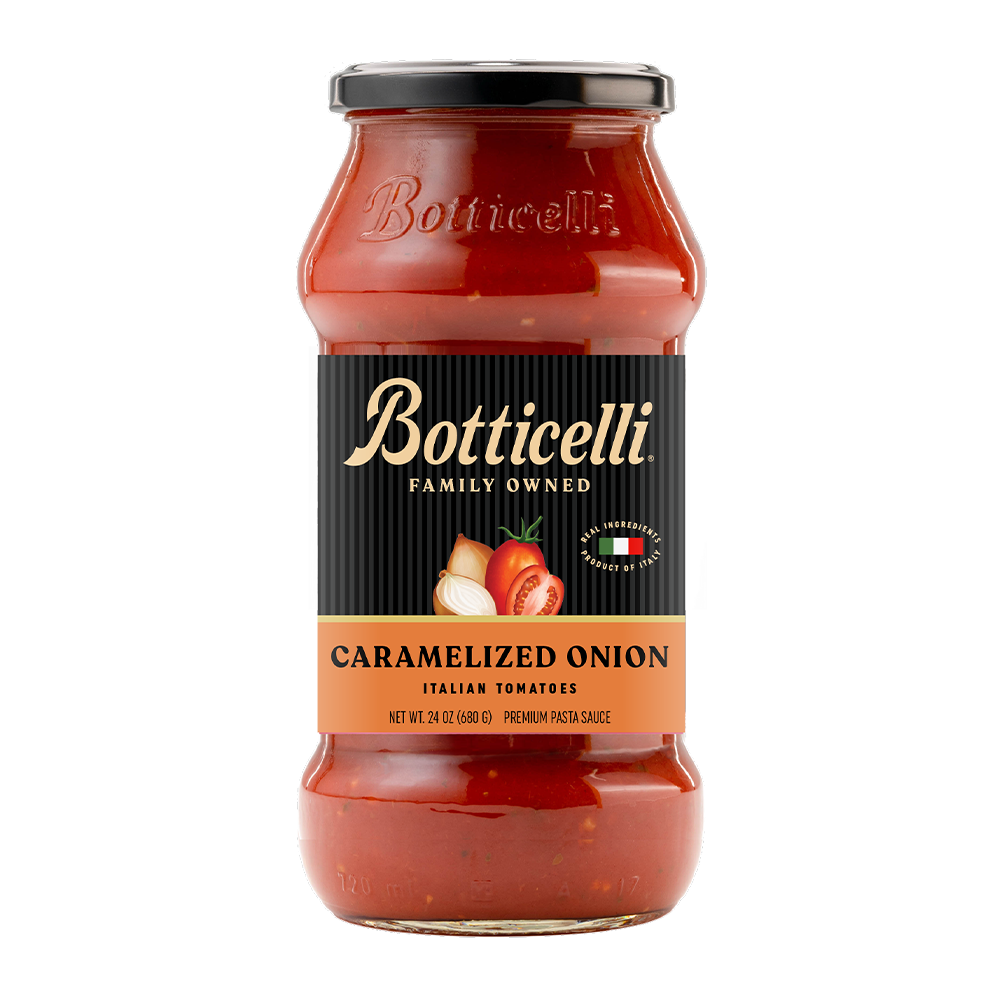 A glass jar of Botticelli Family Owned Caramelized Onion Italian Tomatoes premium pasta sauce, featuring a black label with gold lettering and a black lid, set against a plain white background.