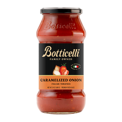 A glass jar of Botticelli Family Owned Caramelized Onion Italian Tomatoes premium pasta sauce, featuring a black label with gold lettering and a black lid, set against a plain white background.
