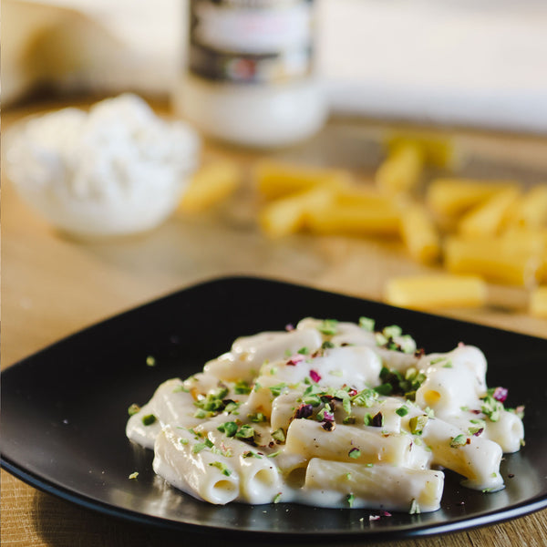 Dish of pasta Alfredo and pistachio